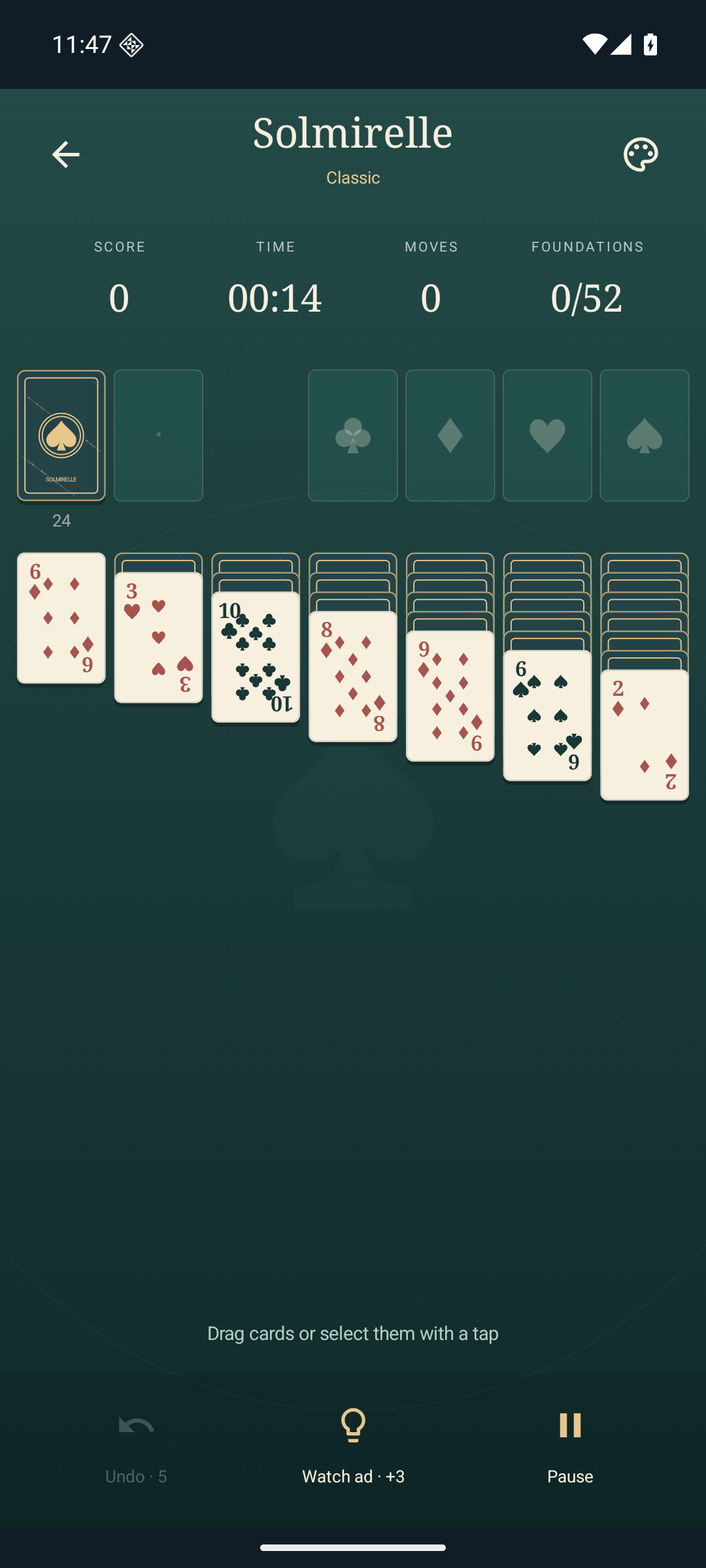 Solmirelle Classic solitaire on a jade green table, with cream cards and gold details